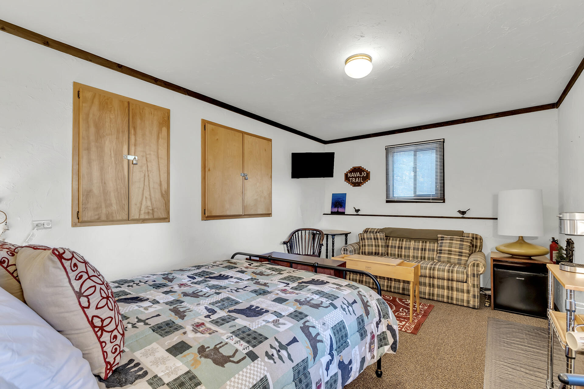 25121 Pine Cove Road Idyllwild, CA 92549 - Photo 55 of 65 a bedroom with a bed and wooden floor