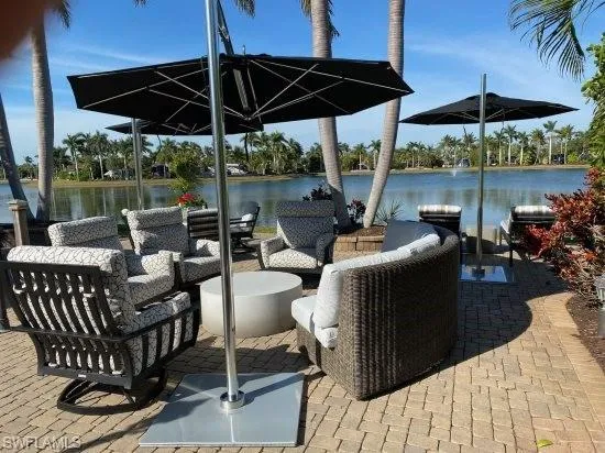 a patio with patio a table and chairs under an umbrella