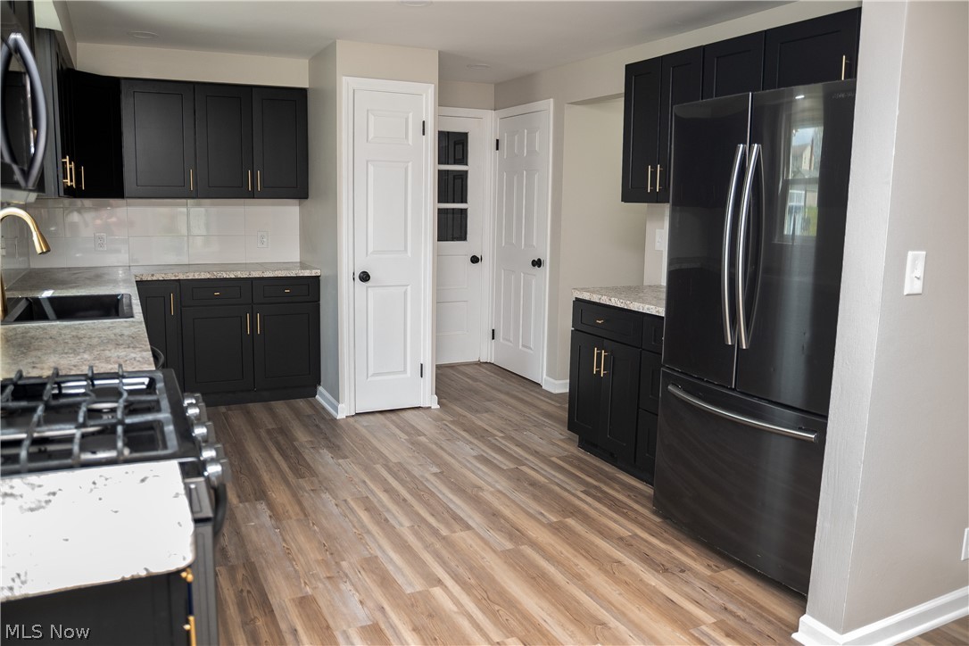 6666 Clingan Road Youngstown, OH 44514 - Photo 15 of 41 Kitchen with view of pantry, new cabinets, backsplash, countertops and garage man door