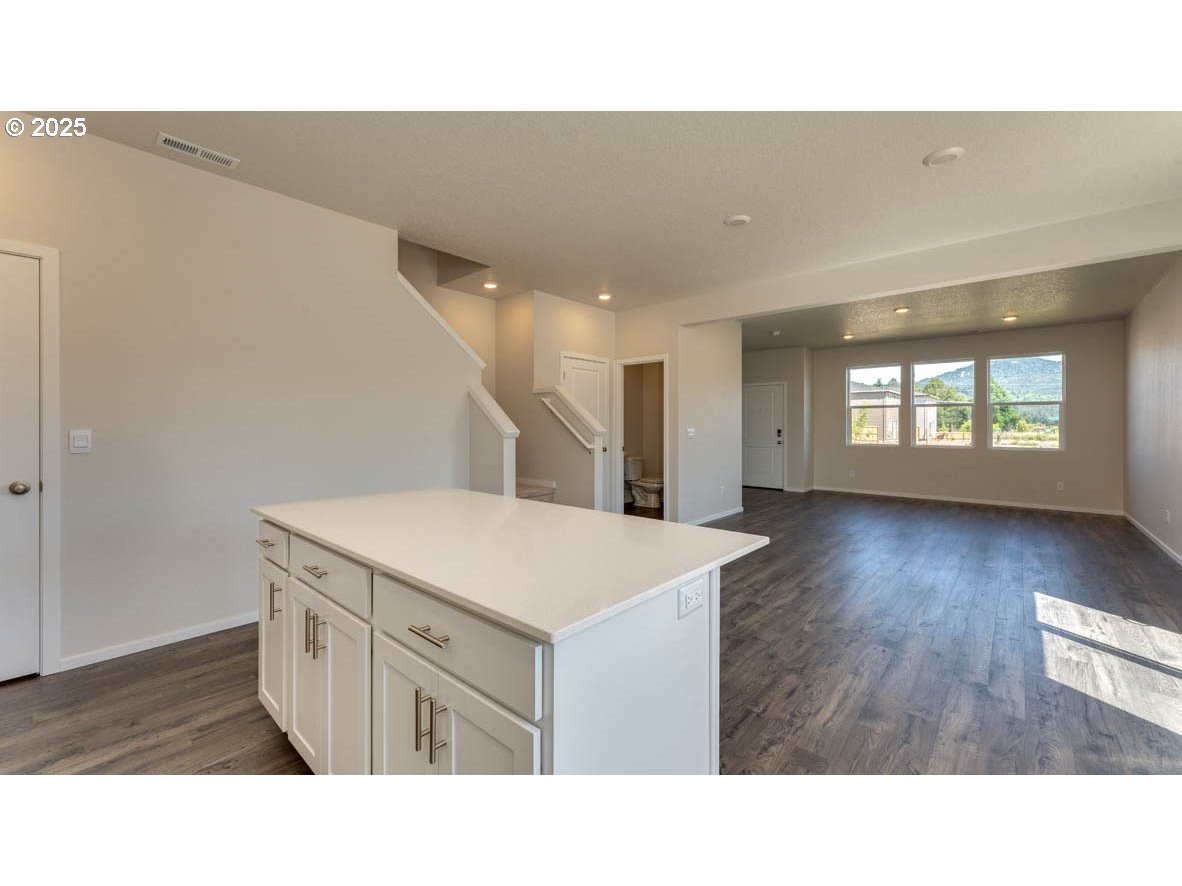2873 V Street Springfield, OR 97477 - Photo 9 of 22 a kitchen with a sink a stove and dishwasher with wooden floor