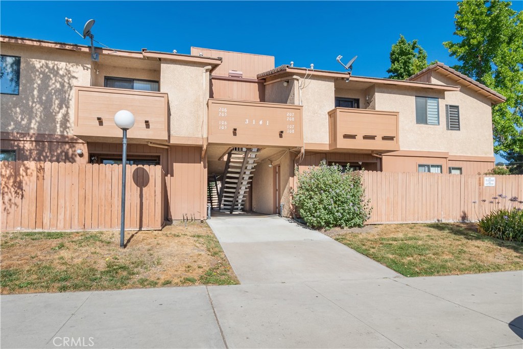 3141 Spring Street, Unit 108 Paso Robles, CA 93446 - Photo 1 of 1 a view of a white house with large windows