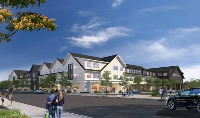 a living room with furniture two large windows and wooden floor