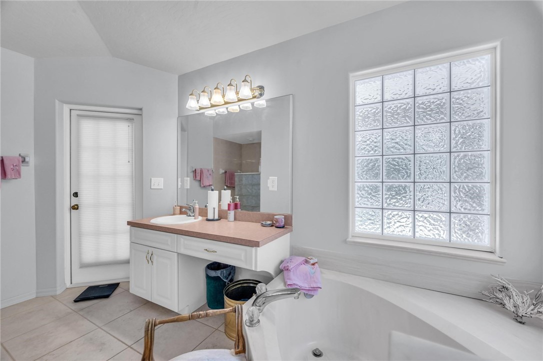 1641 Laconia Street Sebastian, FL 32958 - Photo 11 of 32 a bathroom with a sink bath tub and a window