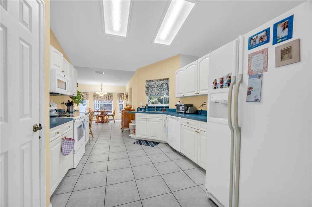 1641 Laconia Street Sebastian, FL 32958 - Photo 14 of 32 a kitchen with stainless steel appliances a refrigerator and cabinets