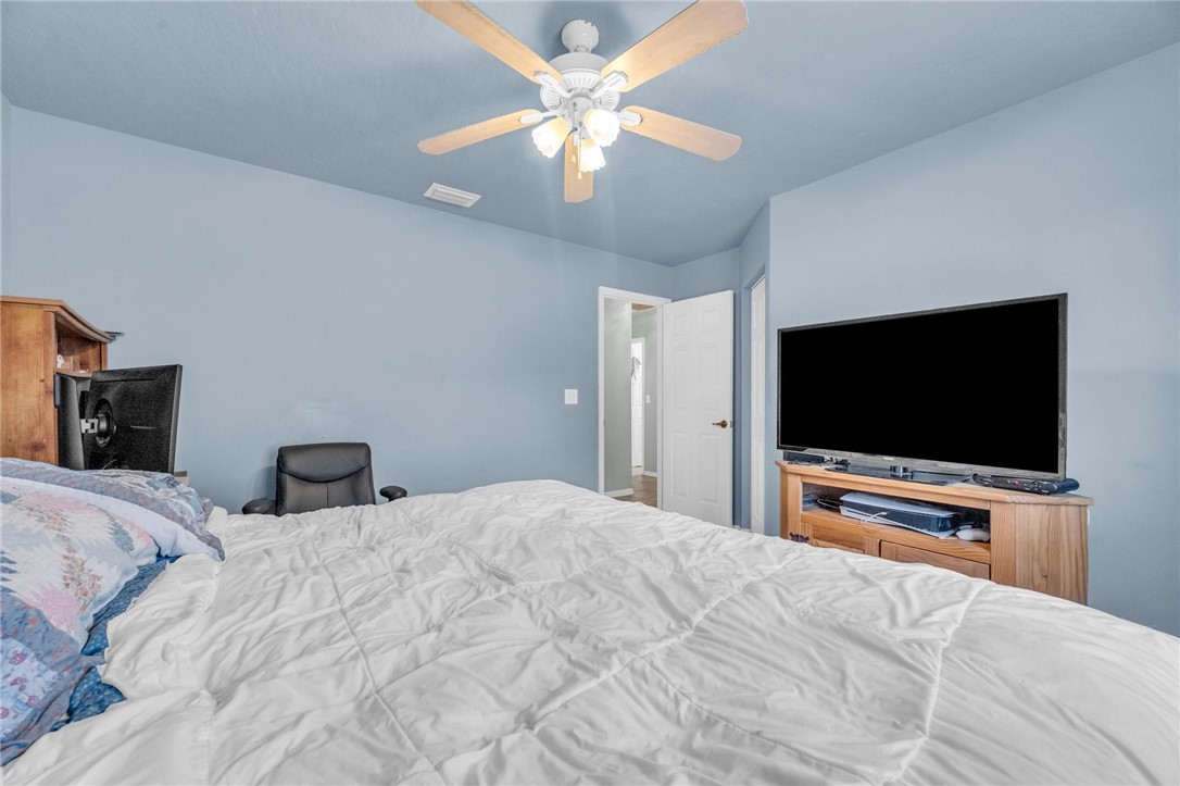 1641 Laconia Street Sebastian, FL 32958 - Photo 22 of 32 a bedroom with a bed and a flat screen tv