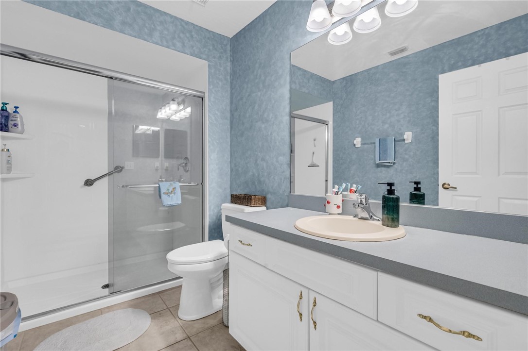 1641 Laconia Street Sebastian, FL 32958 - Photo 23 of 32 a bathroom with a sink a toilet and shower