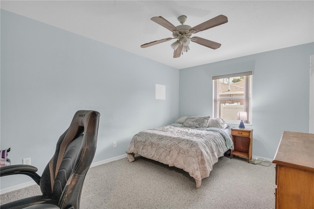 1641 Laconia Street Sebastian, FL 32958 - Photo 24 of 32 a bedroom with a bed a desk and chair