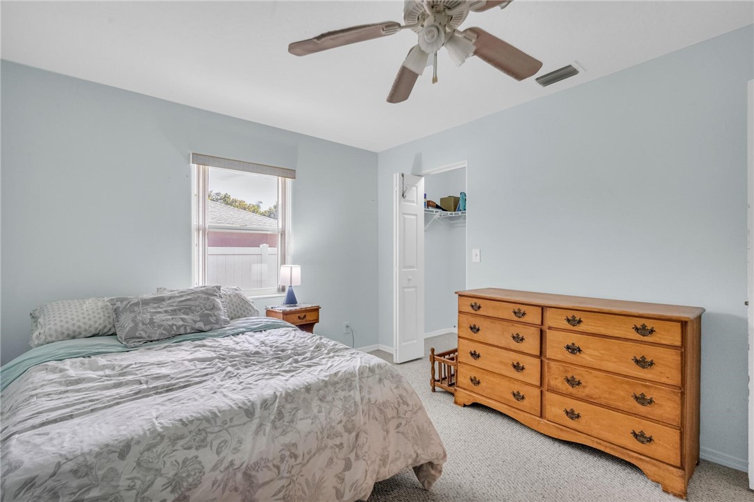 1641 Laconia Street Sebastian, FL 32958 - Photo 25 of 32 a bedroom with a bed and a dresser