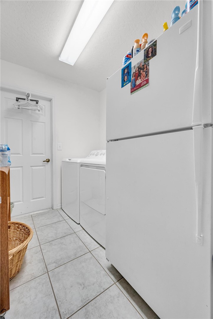 1641 Laconia Street Sebastian, FL 32958 - Photo 26 of 32 a kitchen with white cabinets and refrigerator