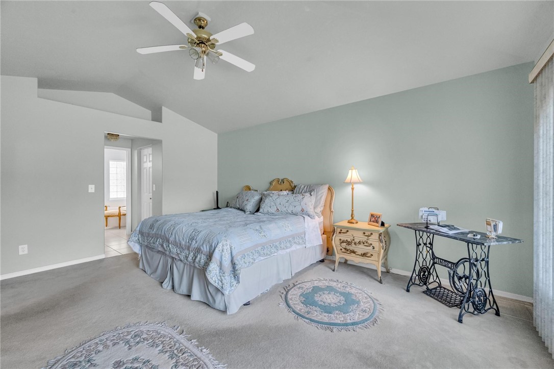1641 Laconia Street Sebastian, FL 32958 - Photo 9 of 32 a spacious bedroom with a bed and a chandelier
