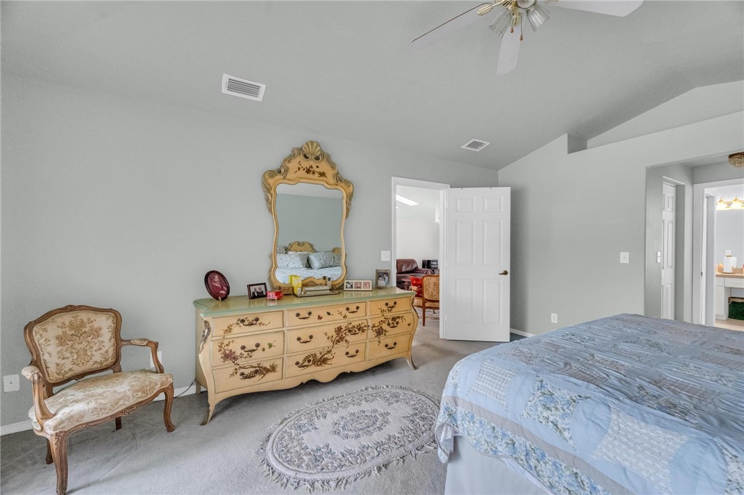 1641 Laconia Street Sebastian, FL 32958 - Photo 10 of 32 a bedroom with a bed and a chandelier