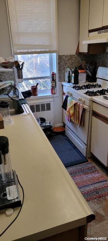 87-05 166th Street, Unit 4G Queens, NY 11432 - Photo 7 of 10 a kitchen with stainless steel appliances granite countertop a sink a stove and a microwave