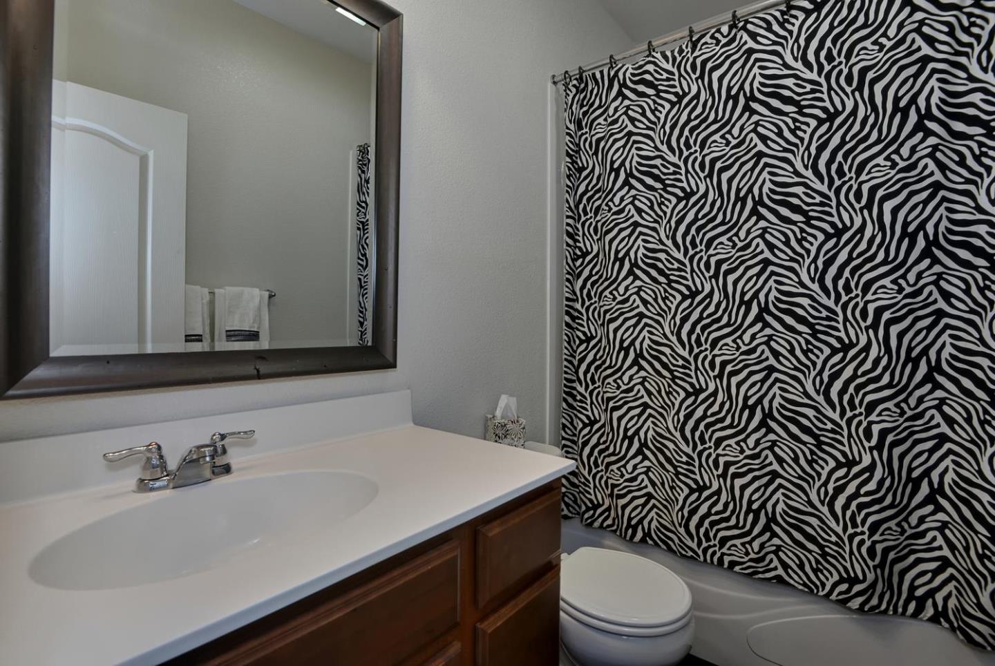 2870 Monroe Terrace San Jose, CA 95128 - Photo 17 of 28 a bathroom with a sink a toilet and mirror