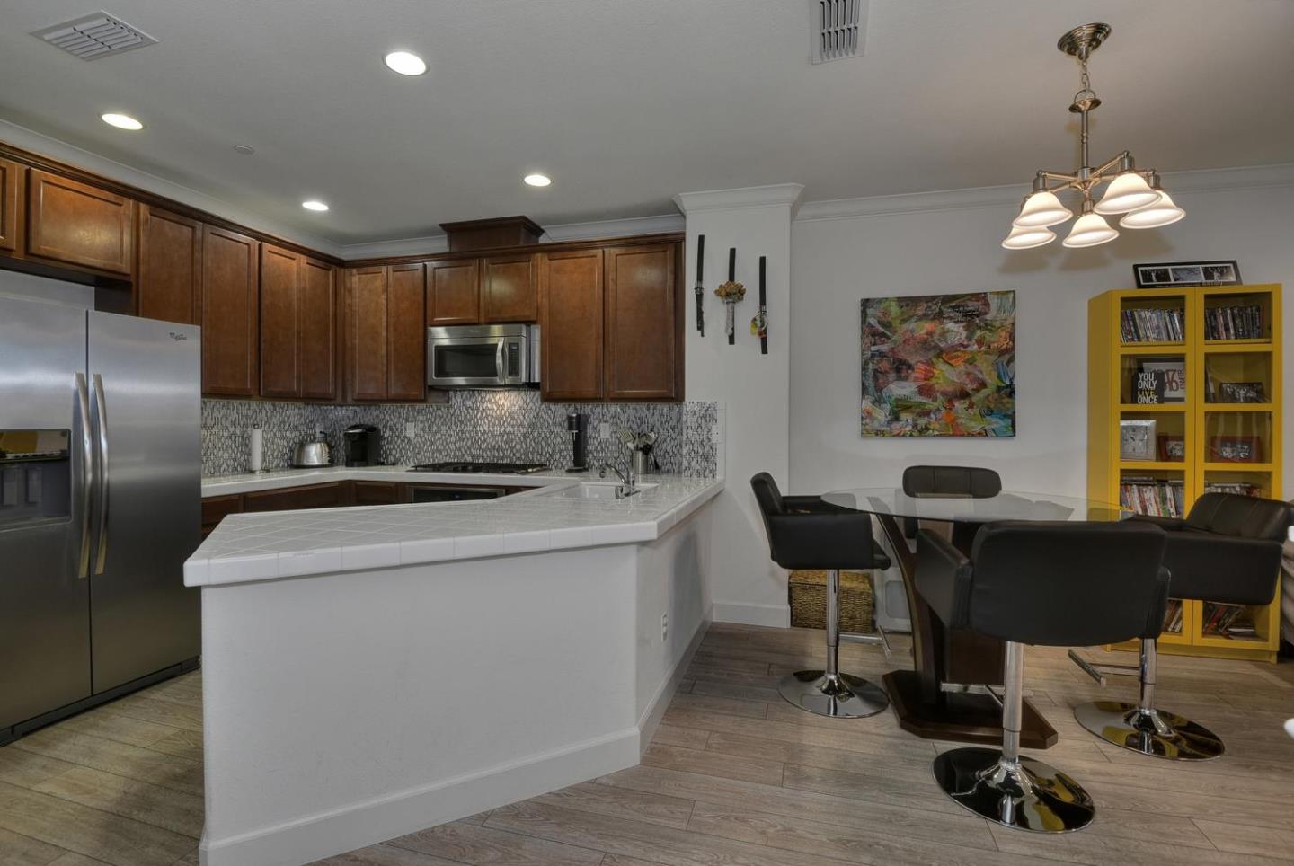 2870 Monroe Terrace San Jose, CA 95128 - Photo 8 of 28 a kitchen that has a cabinets counter space and a dining table