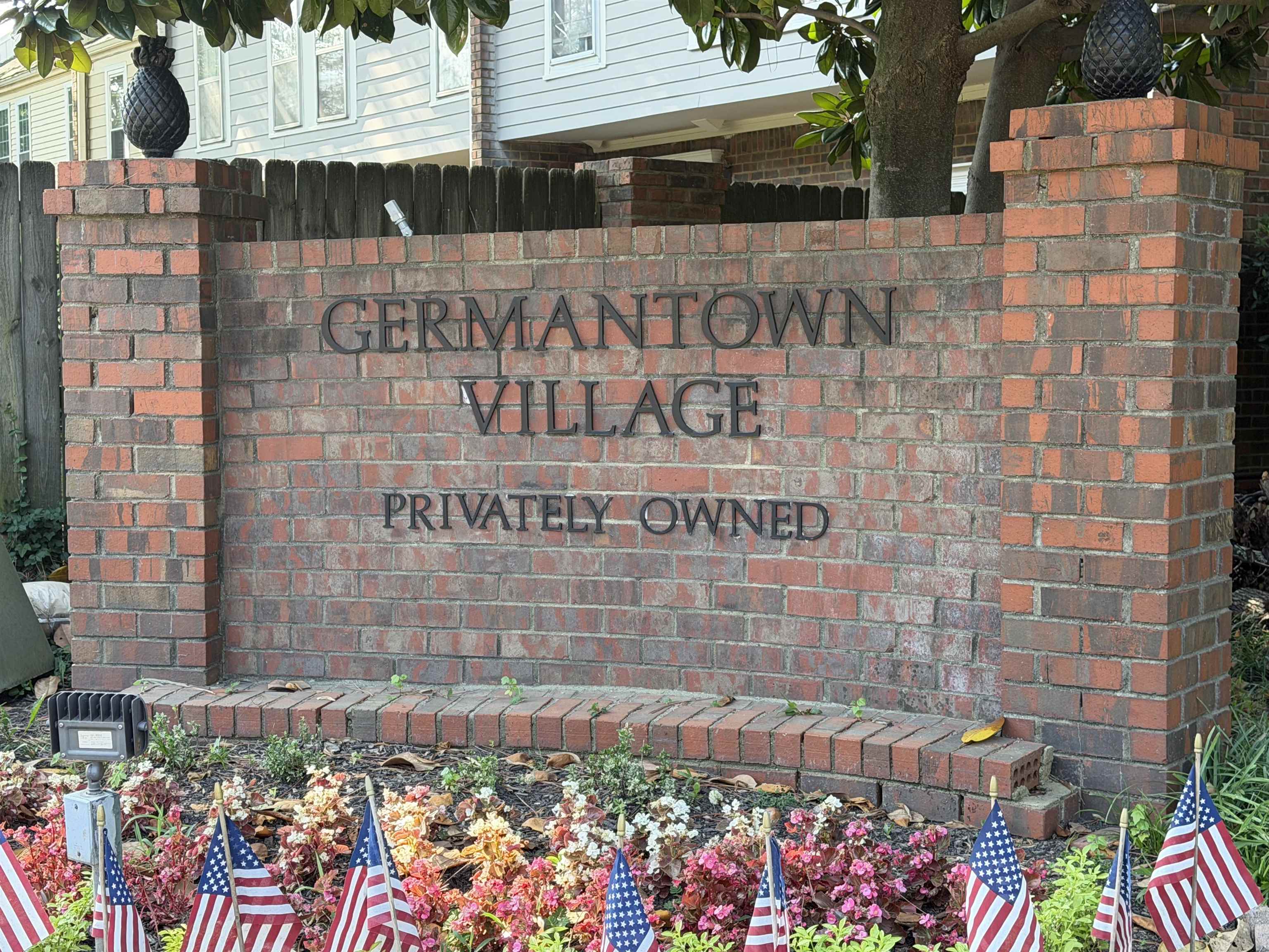 6913 Climping Road, Unit 6913 Memphis, TN 38119 - Photo 2 of 32 Brick entry monument with raised lettering and decorative pineapple finials, featuring a landscaped base