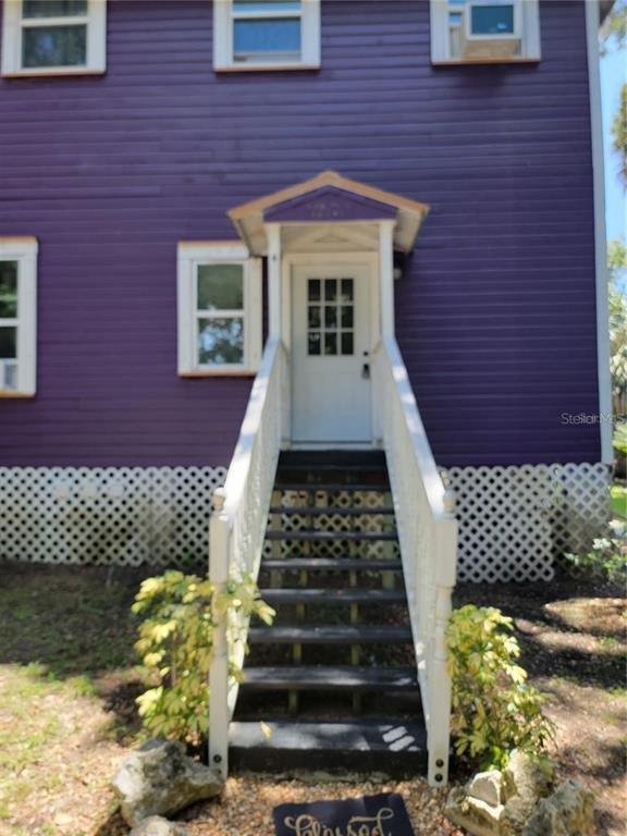 965 Northeast 2nd Street, Unit 4 Ocala, FL 34470 - Photo 1 of 4 a front view of a house with a garden