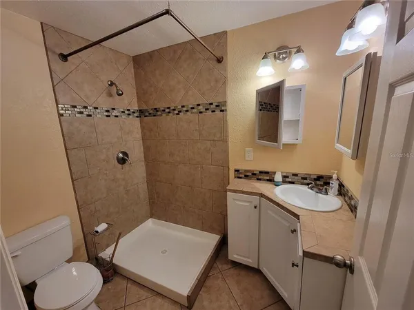 a bathroom with a sink toilet and shower