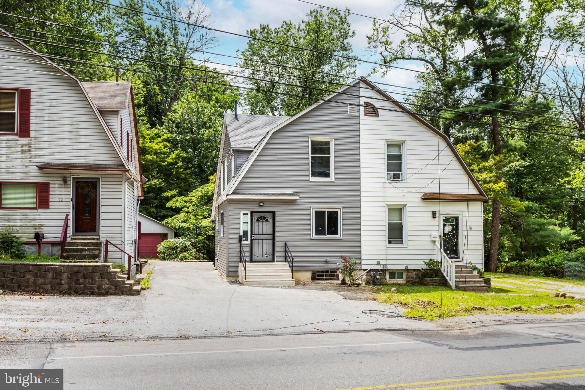 a view of a yard in front view of a house