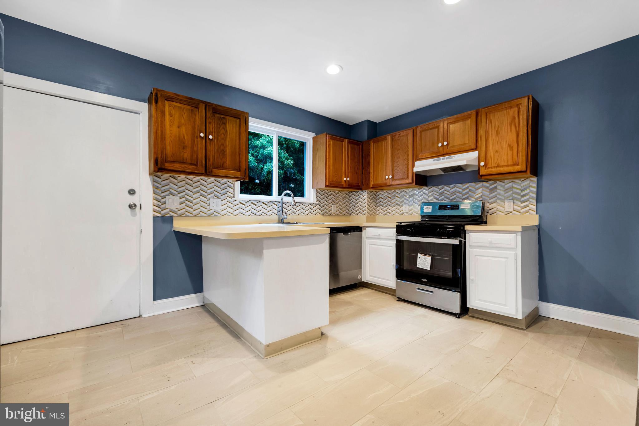 14 West Providence Road Lansdowne, PA 19050 - Photo 11 of 22 a kitchen with stainless steel appliances granite countertop a stove a sink and a refrigerator