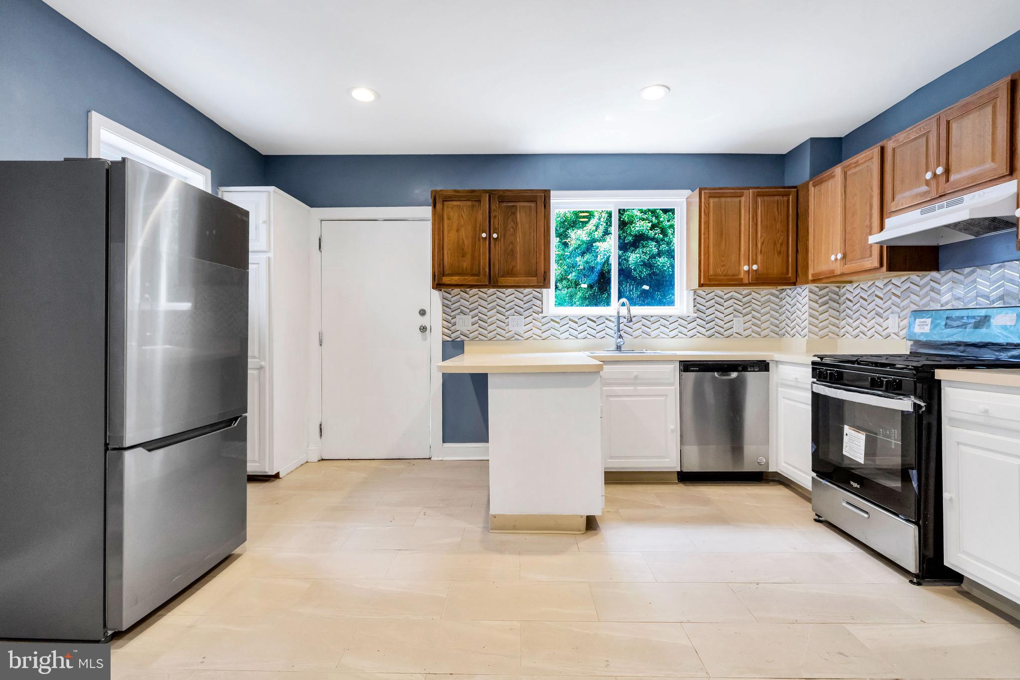 14 West Providence Road Lansdowne, PA 19050 - Photo 12 of 22 a kitchen with a stove a sink and a refrigerator