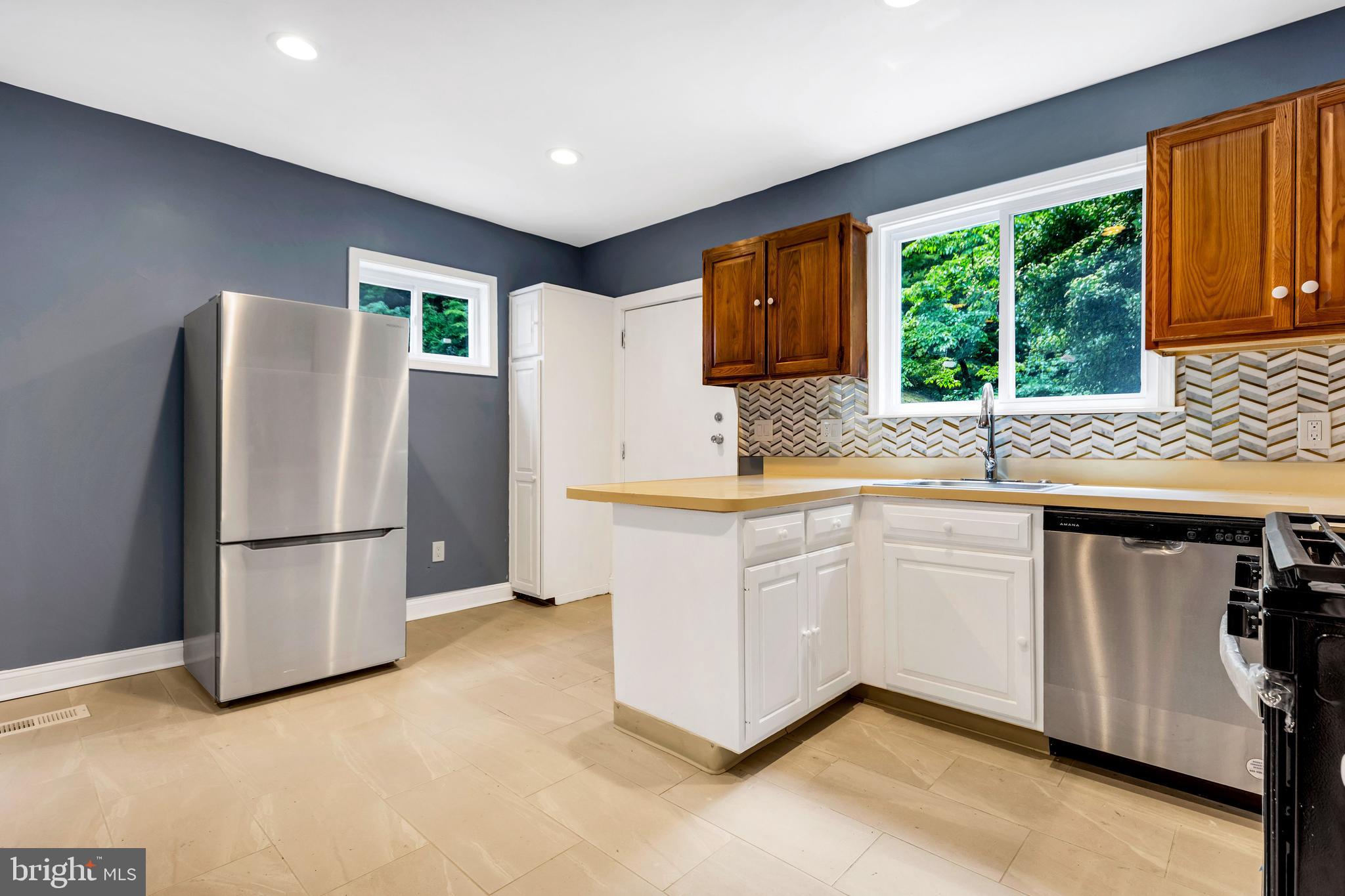 14 West Providence Road Lansdowne, PA 19050 - Photo 13 of 22 a kitchen with a refrigerator and a sink