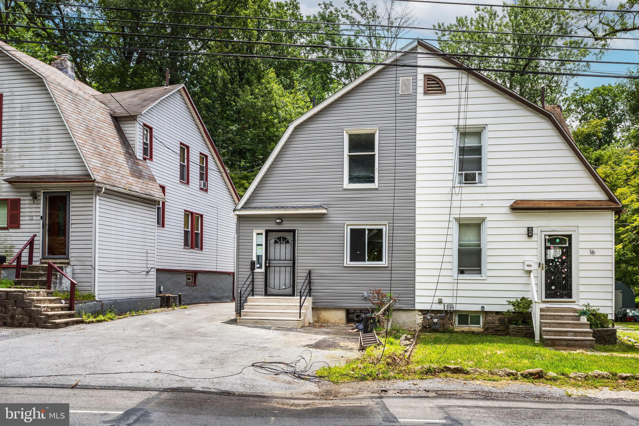14 West Providence Road Lansdowne, PA 19050 - Photo 2 of 22 a view of a white house with large windows next to a road