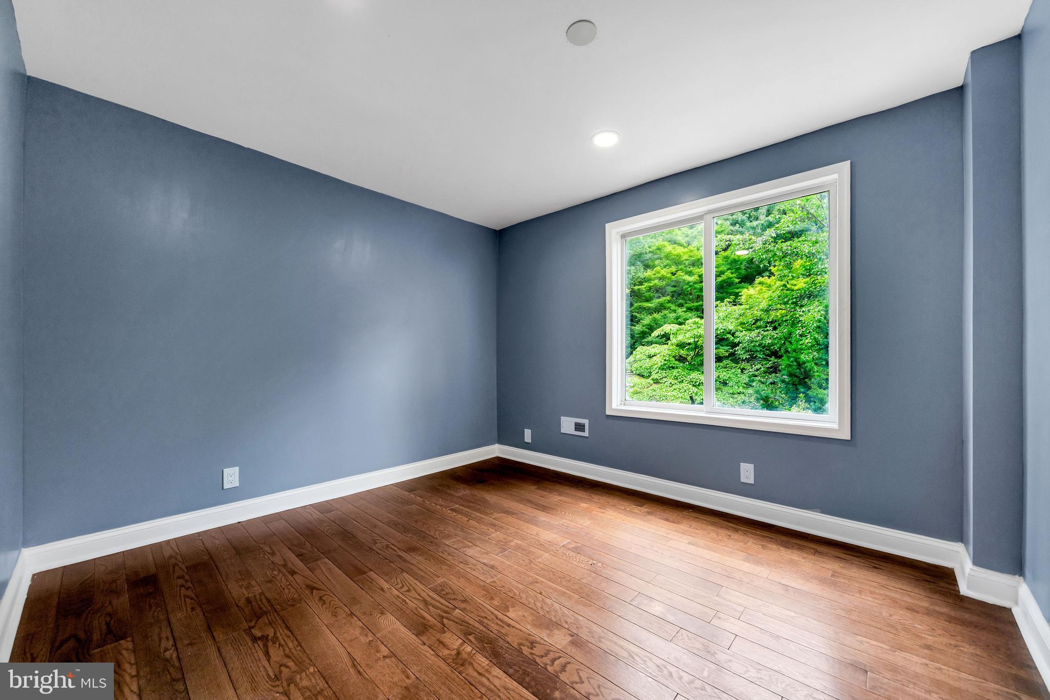 14 West Providence Road Lansdowne, PA 19050 - Photo 4 of 22 an empty room with wooden floor and windows
