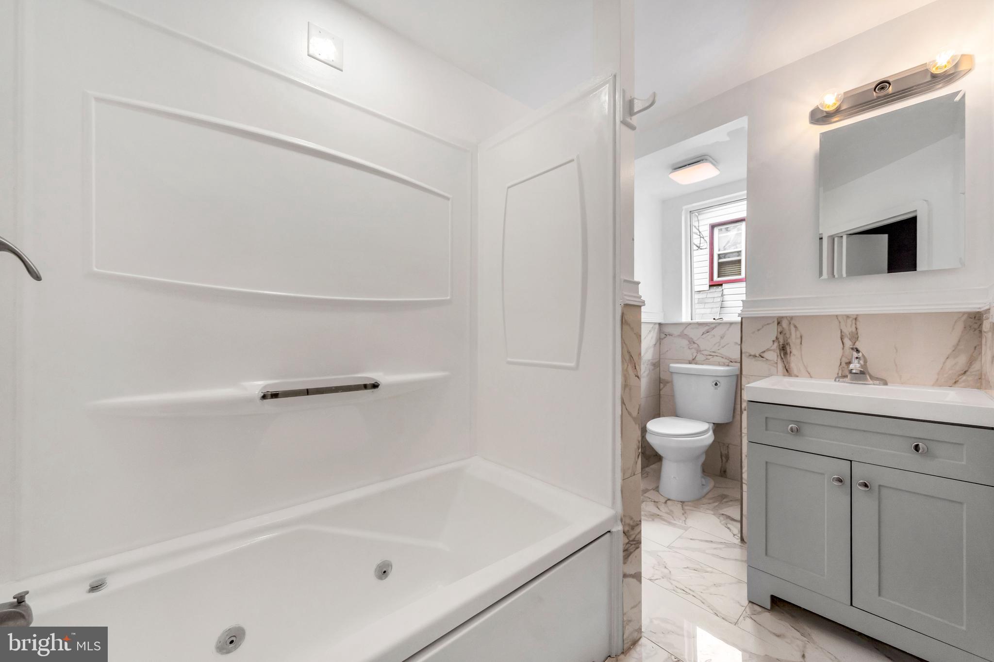 14 West Providence Road Lansdowne, PA 19050 - Photo 6 of 22 a bathroom with a granite countertop sink a toilet and bathtub