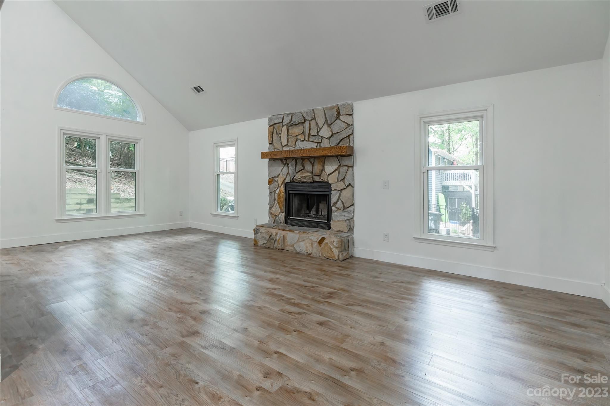 2117 Bon Villa Way Tega Cay, SC 29708 - Photo 5 of 25 a view of an empty room with wooden floor fireplace and a window