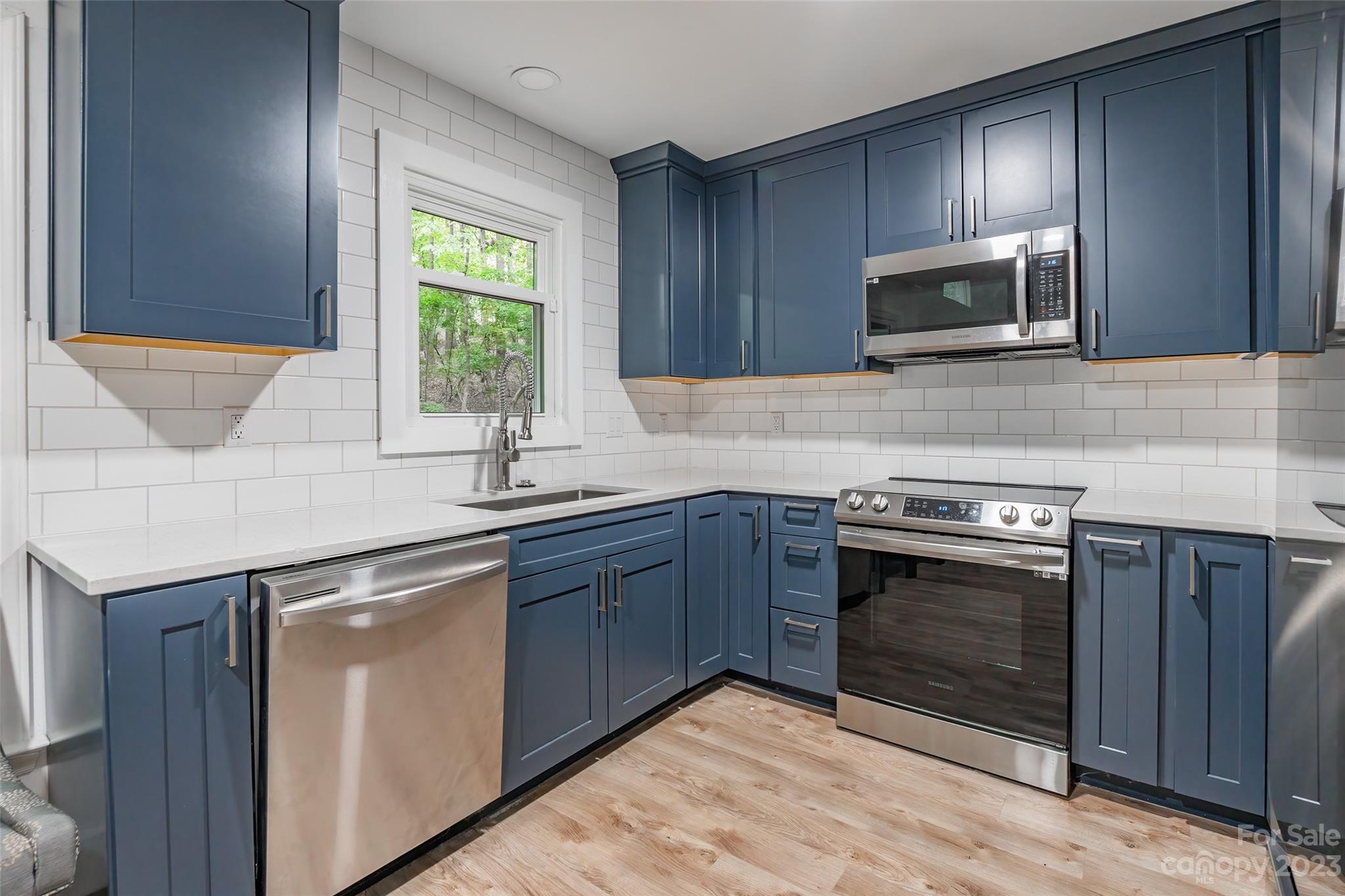 2117 Bon Villa Way Tega Cay, SC 29708 - Photo 8 of 25 a kitchen with stainless steel appliances granite countertop a sink stove and microwave