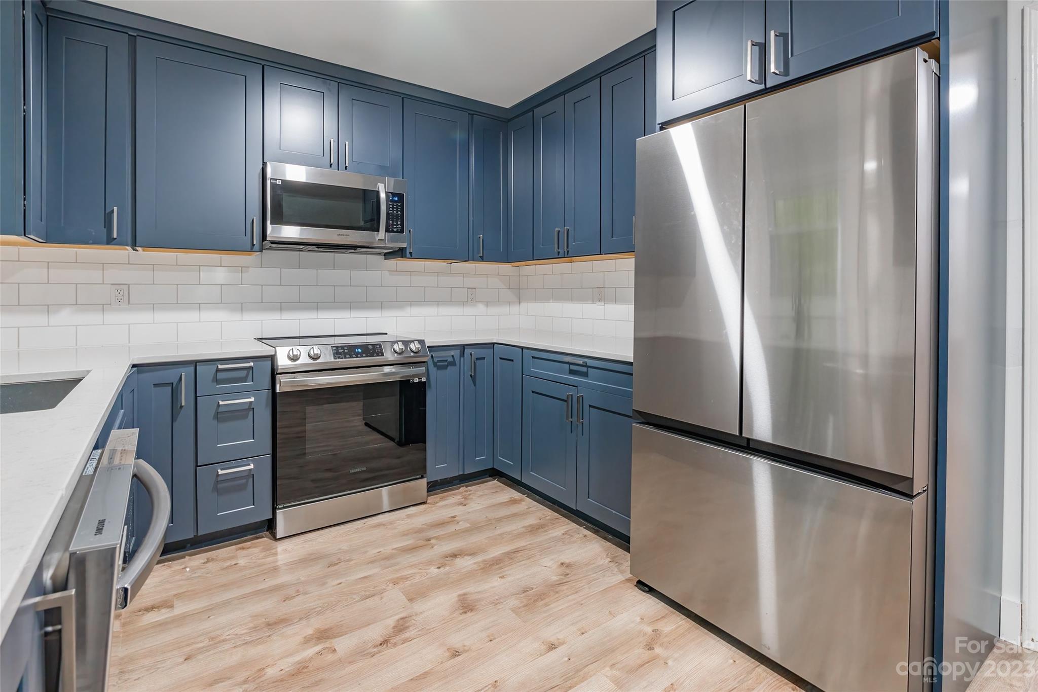 2117 Bon Villa Way Tega Cay, SC 29708 - Photo 9 of 25 a kitchen with stainless steel appliances granite countertop a refrigerator stove and sink