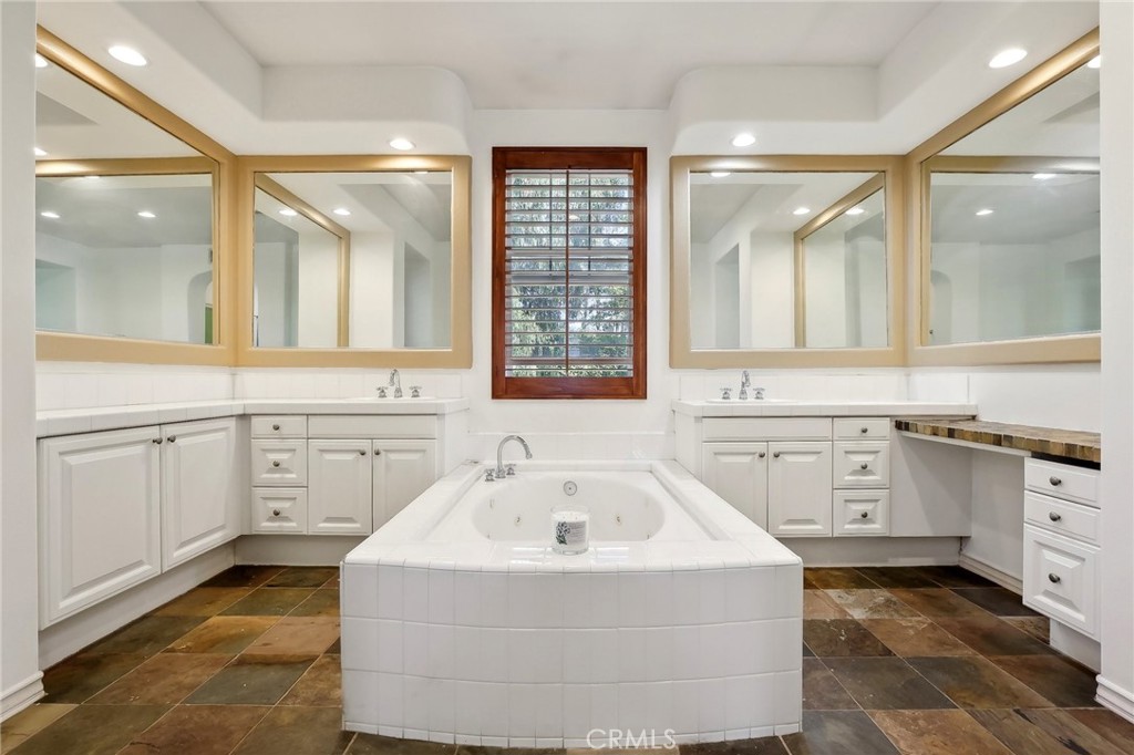 18 Winfield Drive Ladera Ranch, CA 92694 - Photo 21 of 39 a bathroom with a granite countertop sink mirror and bathtub