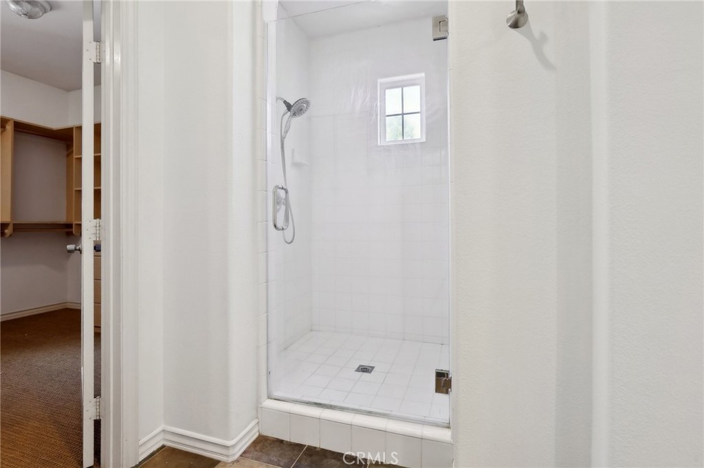 18 Winfield Drive Ladera Ranch, CA 92694 - Photo 22 of 39 a bathroom with a glass shower door