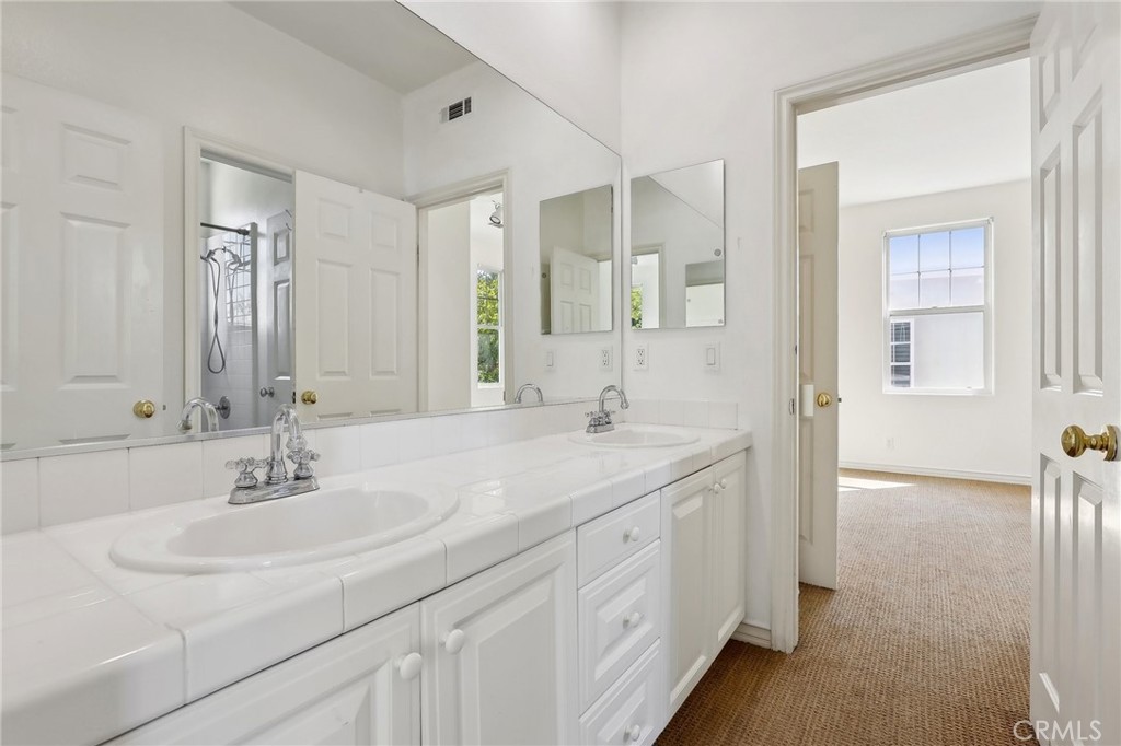 18 Winfield Drive Ladera Ranch, CA 92694 - Photo 26 of 39 a bathroom with a sink and a mirror