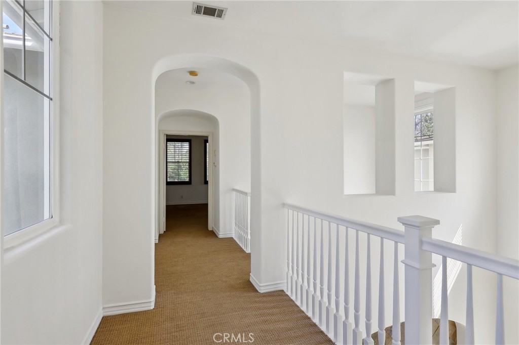 18 Winfield Drive Ladera Ranch, CA 92694 - Photo 32 of 39 a view of a hallway with wooden floor and a bathroom