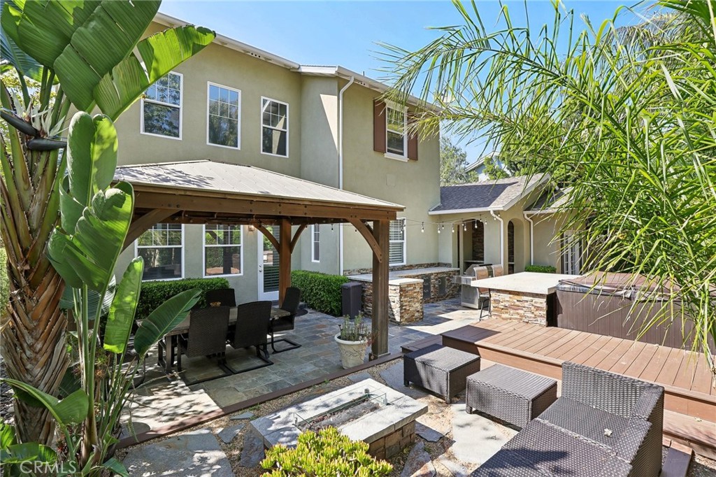 18 Winfield Drive Ladera Ranch, CA 92694 - Photo 38 of 39 a view of a patio with table and chairs potted plants and large tree
