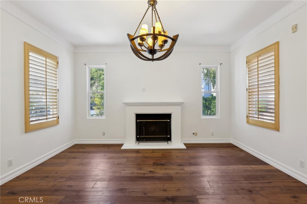 18 Winfield Drive Ladera Ranch, CA 92694 - Photo 8 of 39 an empty room with wooden floor a fireplace and windows