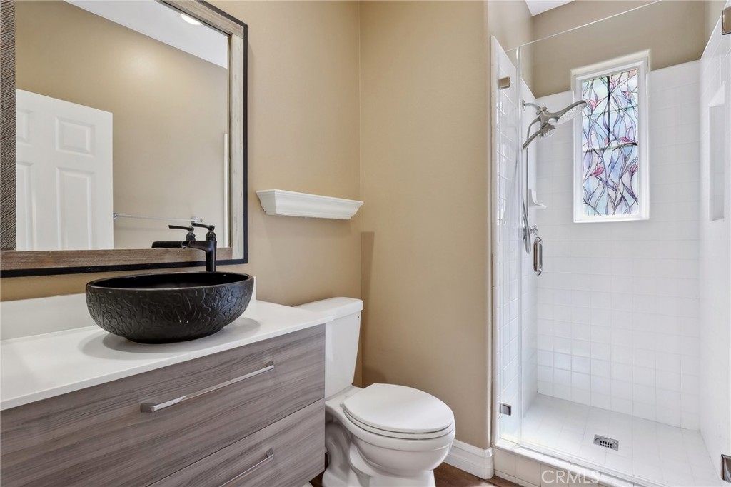 18 Winfield Drive Ladera Ranch, CA 92694 - Photo 9 of 39 a bathroom with a granite countertop sink a toilet and a shower