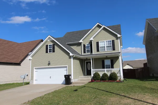 a front view of a house with a yard and garage