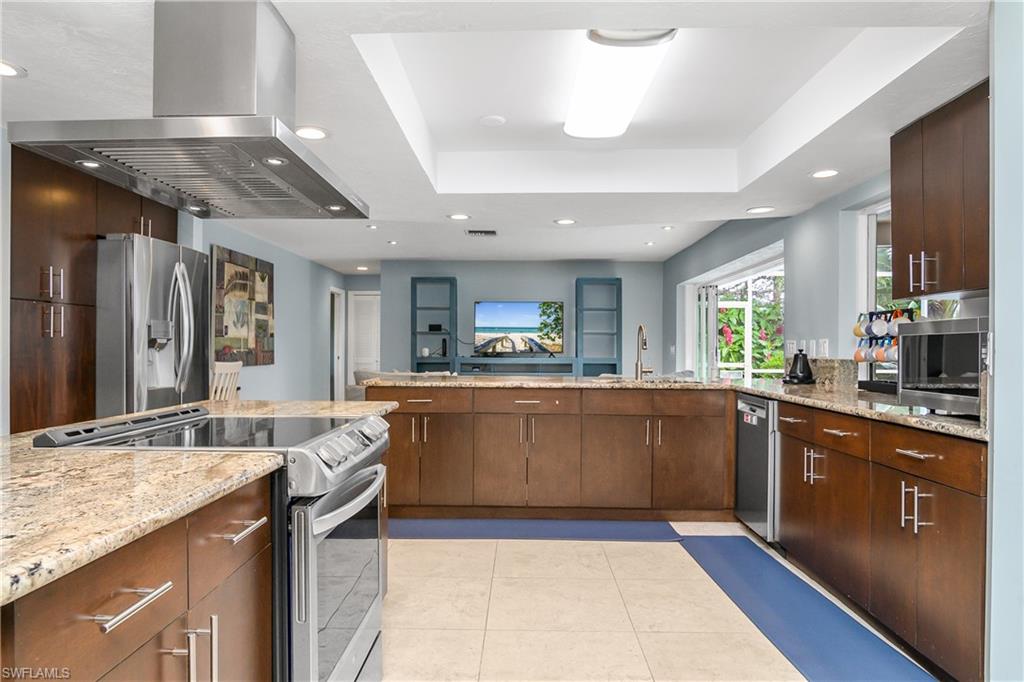 330 Country Club Drive Naples, FL 34110 - Photo 11 of 37 a large kitchen with granite countertop lots of counter space and sink