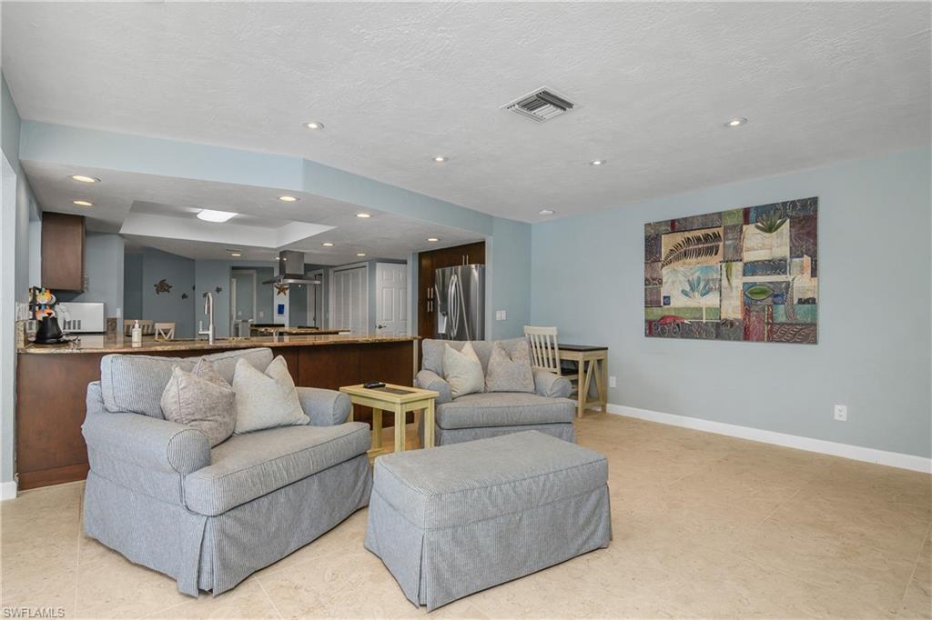 330 Country Club Drive Naples, FL 34110 - Photo 13 of 37 a living room with furniture and a view of kitchen