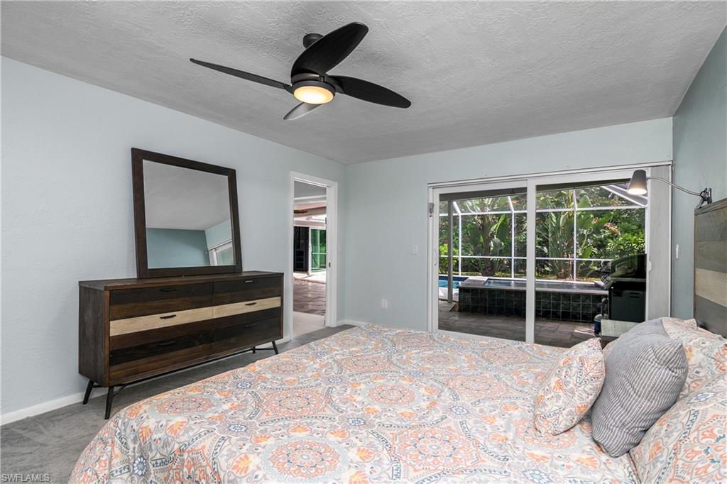330 Country Club Drive Naples, FL 34110 - Photo 16 of 37 a bedroom with a bed and a large window