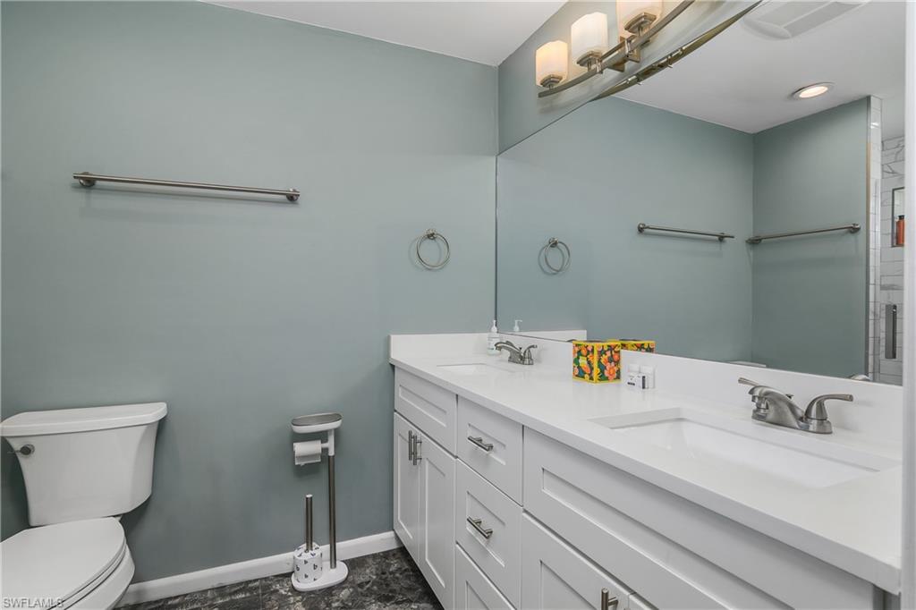 330 Country Club Drive Naples, FL 34110 - Photo 20 of 37 a bathroom with a sink a toilet and a mirror