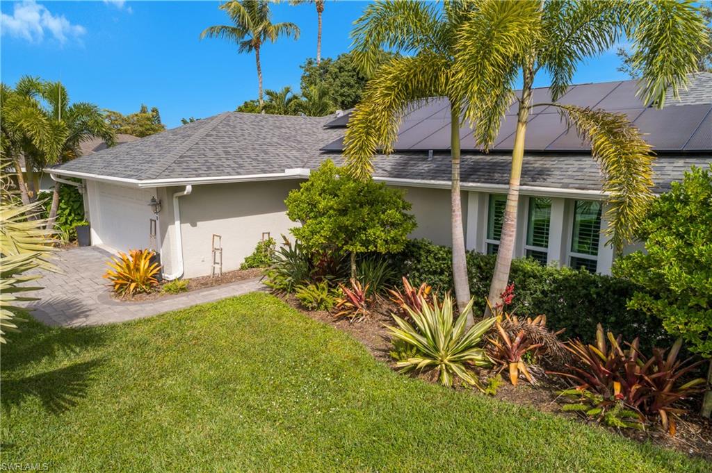 330 Country Club Drive Naples, FL 34110 - Photo 2 of 37 a view of a house with a yard
