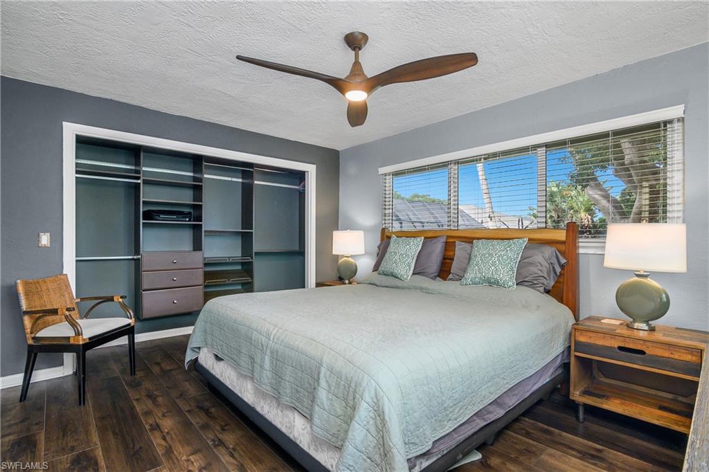 330 Country Club Drive Naples, FL 34110 - Photo 21 of 37 a bedroom with a bed and a chandelier