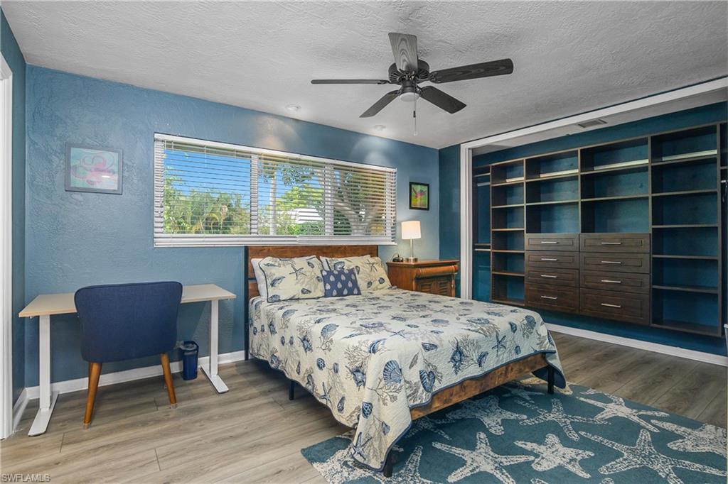 330 Country Club Drive Naples, FL 34110 - Photo 22 of 37 a bedroom with a bed and a chair