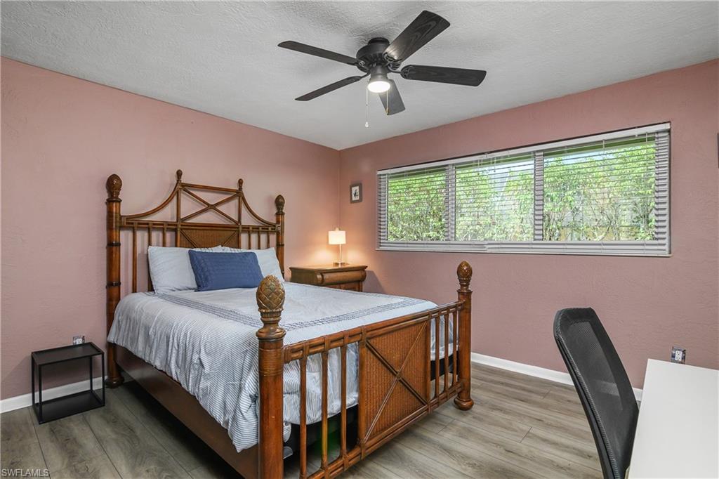 330 Country Club Drive Naples, FL 34110 - Photo 23 of 37 a bedroom with a bed window and a desk