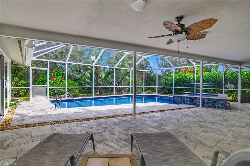 330 Country Club Drive Naples, FL 34110 - Photo 27 of 37 a view of a house with a backyard and a porch