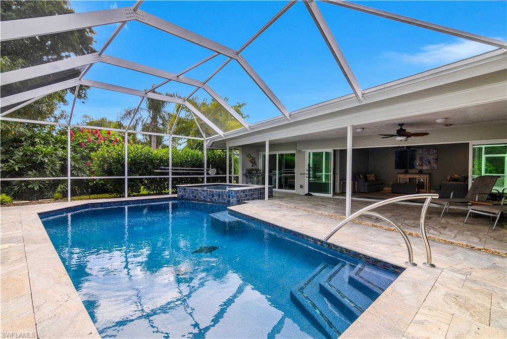330 Country Club Drive Naples, FL 34110 - Photo 31 of 37 a view of a white building with swimming pool in front of it