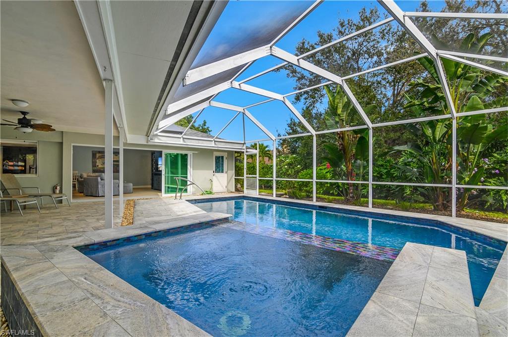 330 Country Club Drive Naples, FL 34110 - Photo 32 of 37 a view of a house with a swimming pool and sitting area